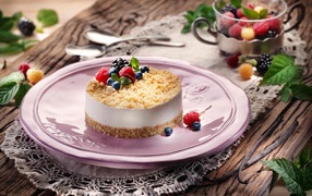 Appetizing cheesecake with raspberries, blueberries and blackberries on a large platter