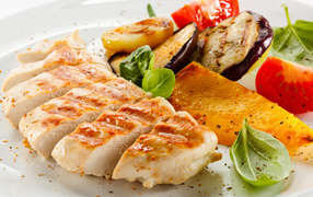 Appetizing fried chicken breast with vegetables
