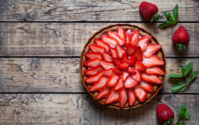 Аппетитный пирог со свежей клубникой на столе 