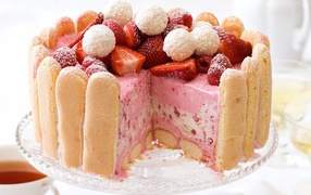 Appetizing strawberry cake with biscuits and berries