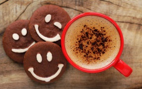 Chocolate biscuits smilies on the table with a cup of coffee