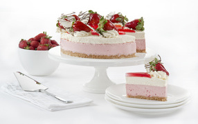 Delicious cake with souffle, white chocolate and strawberries on white background
