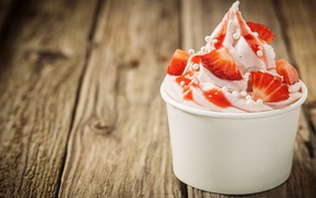 Ice cream with strawberries in a white glass 