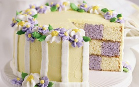 Multicolored cake decorated with flowers from cream
