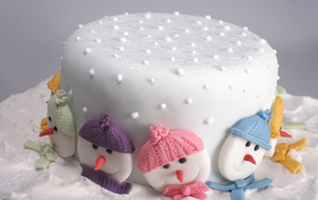 New Year's cake decorated with snowmen from sugar
