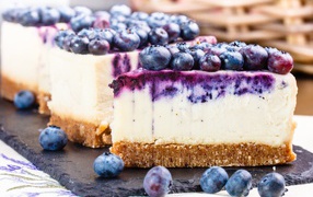 Pieces of cheesecake with berries of delicious blueberries