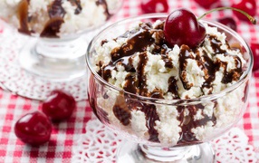 White cream ice cream with chocolate and cherries