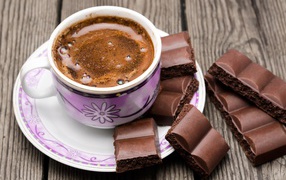 Чашка кофе с черным пористым шоколадом 