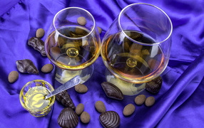 Cognac in glasses with chocolate sweets