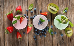 Fresh smoothies from strawberries, blueberries and kiwi on the table top view