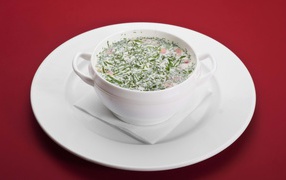 Okroshka in a white bowl on a white plate