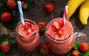 Strawberry smoothies with glass jugs with a straw