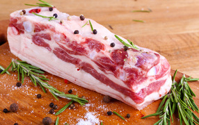 Appetizing fresh bacon with spices and basil