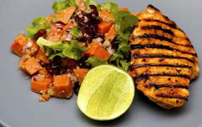 Appetizing slice of grilled chicken grilled on a plate with vegetables