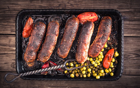 Fried appetizing sausages with vegetables