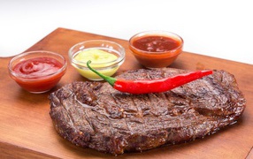 Juicy piece of meat with chili and sauces