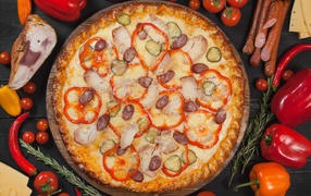Pizza with sweet pepper, pickled cucumbers and sausages