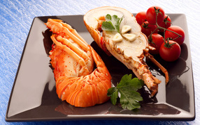 Appetizing boiled lobster on a plate with tomatoes