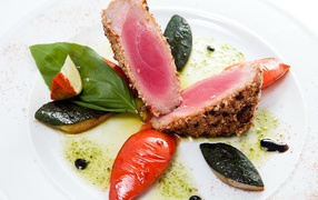 Appetizing tuna steak with vegetables on a white plate
