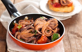 Octopus in the pan on the table