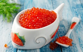 Red caviar with a spoon with a bowl