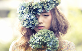 A young asian girl with a wreath of flowers on her head