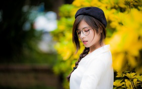 Asian girl with glasses and a black beret