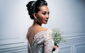 Красивая девушка невеста с белым букетом цветов в руках