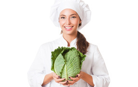 Beautiful girl cook with green cabbage in hands