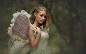 Beautiful girl in a suit with wings