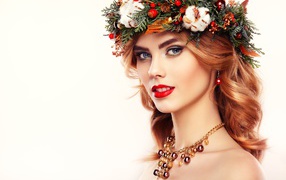 Beautiful young girl with a wreath on her head and beautiful ornaments