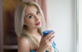 Blonde with pink lips and a glass in her hands