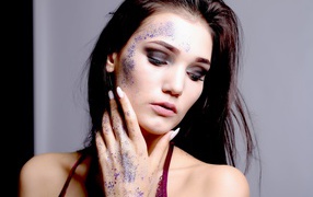 Brunette with sparkles on her face