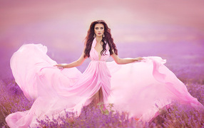 Girl in a beautiful pink dress on a lavender field