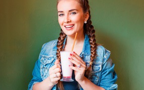 Smiling girl with cocktail in hands