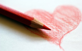 A red heart penciled on a paper