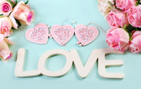 Pink roses, hearts and a white inscription Love in English
