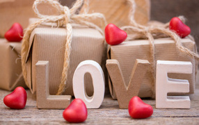 Romantic gifts and the inscription Love with red hearts