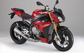 Stylish red BMW S1000R motorcycle on a gray background