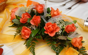 Beautiful bouquet of orange roses with green leaves