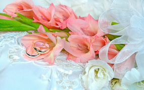 Bouquet of pink gladiolus with two wedding rings