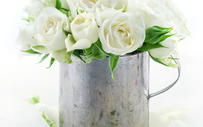 Bouquet of white roses in an iron mug on a white background