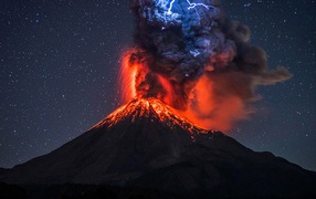 Lightning above the black smoke erupting volcano Colima