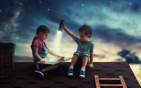 Boy and girl at night reading a book on the roof