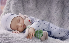 Cute sleeping baby with toy