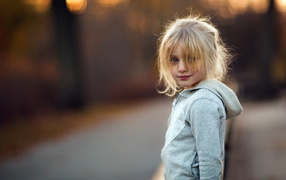 Little blonde girl in gray jacket