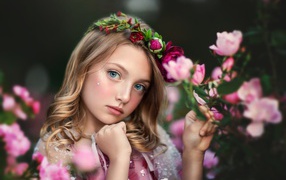 Little blue-eyed girl with flowers