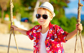 Little boy in a white hat and sunglasses