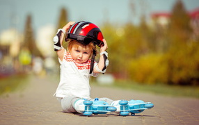 Little boy in helmet and roller skates