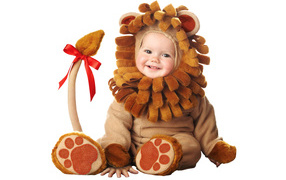 Little cute baby in a lion cub costume on a white background